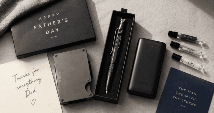 Neatly arranged Father's Day gift flatlay on a light grey linen surface, featuring a slim metal wallet, a multitool pen in a gift box, a compact power bank, and small cologne sample vials, warm natural window light, styled like a lifestyle magazine, top-down angle.