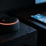 Amazon Echo smart speaker sitting next to a smartphone on a table